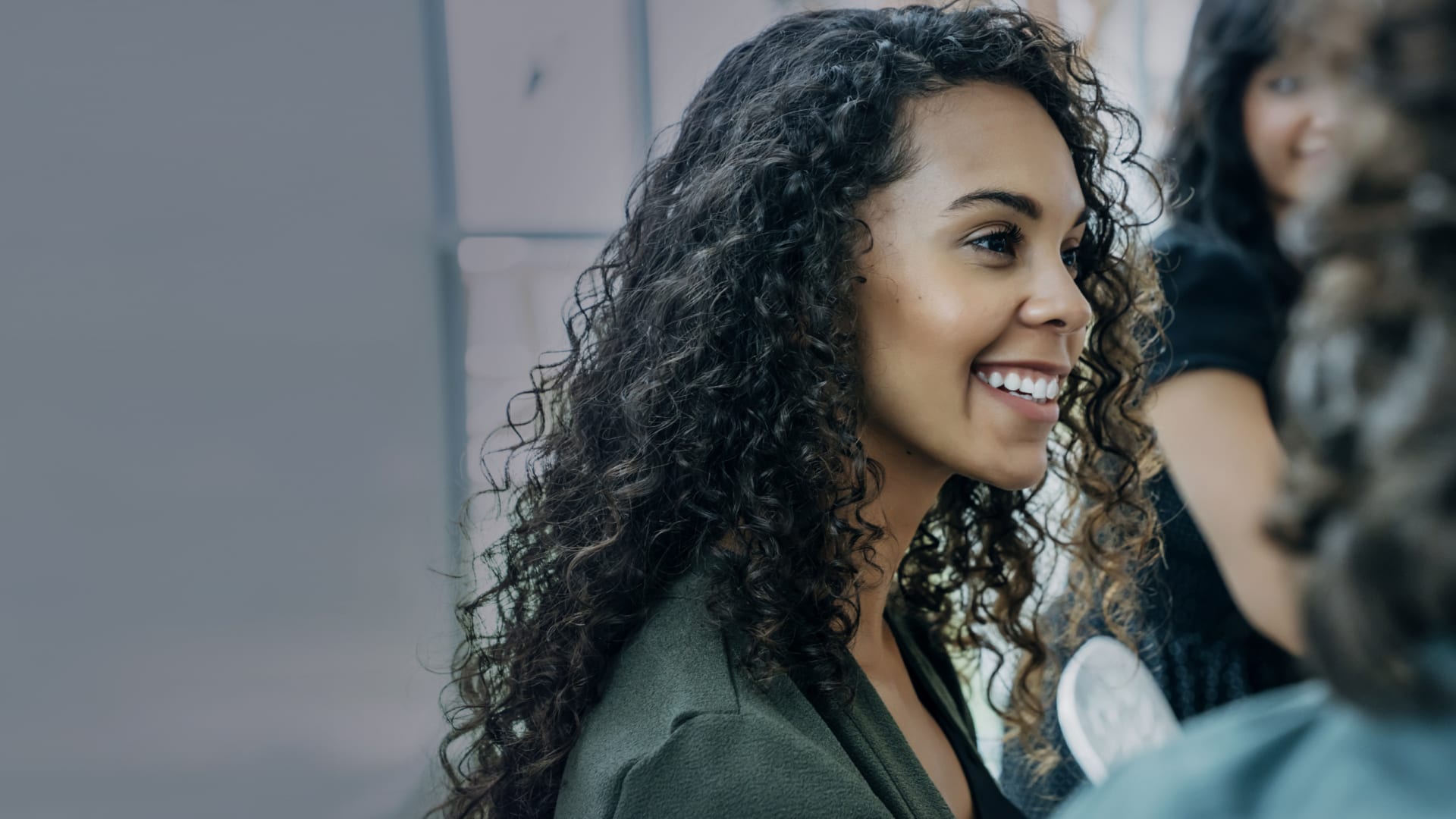 Woman with curly hair smiling